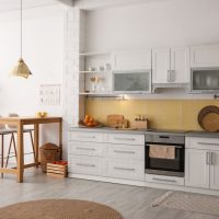 White shaker kitchen cabinets with neutral tiles